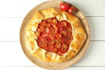 Tasty tomato galette (Caprese galette) on white wooden table, top view