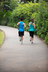 Sporty Asian man and woman running.