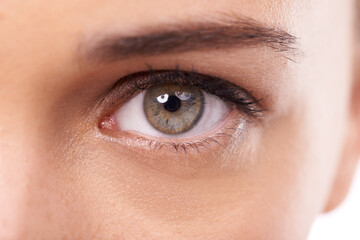 Fototapeta premium Woman, closeup and green eye with makeup in studio and optic health with cosmetics or microblading. Model, healthcare and color for cosmetic contact lens in optometry and ophthalmology for vision