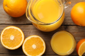 Tasty fresh oranges and juice on wooden table, flat lay
