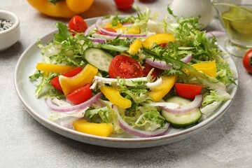 Tasty fresh vegetarian salad on grey table, closeup