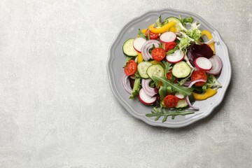 Balanced diet and vegetarian foods. Plate with different delicious products on grey table, top view. Space for text