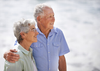 Senior, couple and look happy at beach for retirement vacation or anniversary to relax with love, care and commitment with support. Elderly man, woman and together by ocean for peace on holiday.