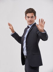 Future, innovation and internet with businessman user in studio on white background for metaverse access. Corporate, digital transformation and touchscreen networking with young employee in suit