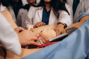 a group of students learns to give birth on a mannequin