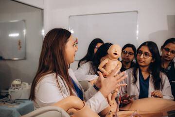 A group of gynecology students performs practical exercises on reproduction of birth processes on a...