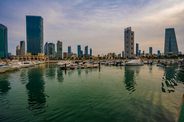 Obraz premium Harbor Life at Souq Sharq Marina with Kuwait City Skyline