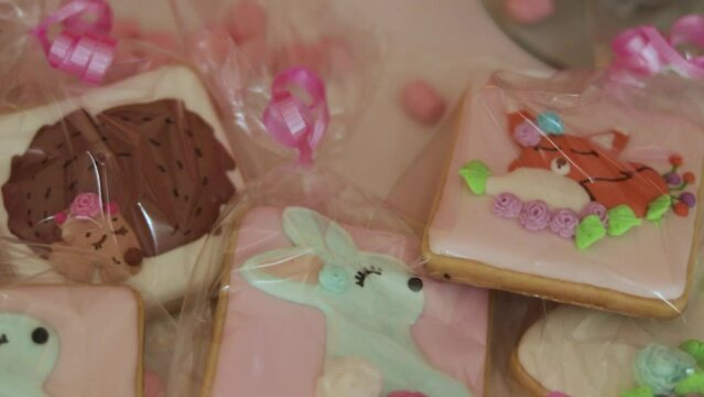 Homemade glazed animal cookies wrapped in plastic as presents