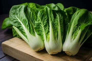 pak choi or boy choy celery green cabbage in the kitchen as cooking ingredient closeup. Chinese and asian cuisine. Vegan food. - obrazy, fototapety, plakaty