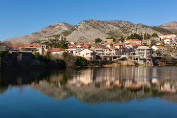 Trebinje city. Balkan houses in city center with red roofs and mountains at background, Balkan vibe. Old city Trebinje, Bosnia and Herzegovina