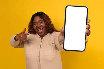 Chubby Black Woman Showing Big Smartphone With White Blank Screen - obrazy, fototapety, plakaty