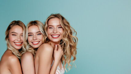 Trio of radiant women laughing together with visible joy, set against a vibrant teal background