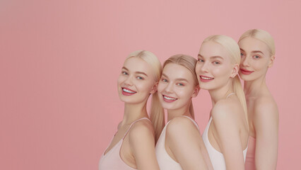 Seven young women lined up with a mixture of smiles and neutral expressions on a gentle pink backdrop