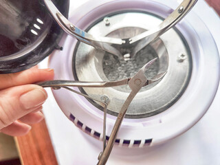 A tool for high-temperature sterilization and cleaning of metal manicure tools. Sterilization of nail clippers at home or in a beauty salon