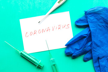 Disposable syringes, thermometer and white mockup blank on green background. Chinese Coronavirus...