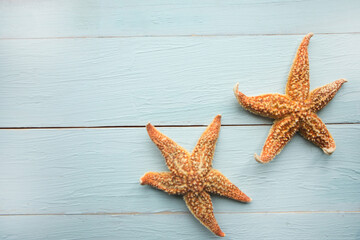 Two starfishes on wooden background. Copy space for the text. Summer vacation concept