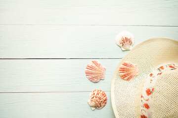   Hat and seashells on wooden background. Summer vacation concept. Copy space for the text