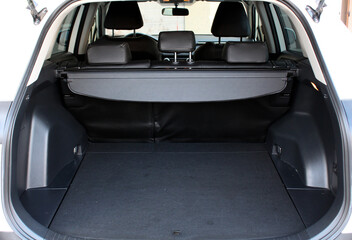Premium SUV open trunk. Open empty trunk in the modern SUV. Car boot space shot. Modern SUV open trunk. Ready for luggage loading. Front view.