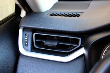 SUV Car air vents close-up grille. Air ventilation grille with power regulator. Modern Car air...