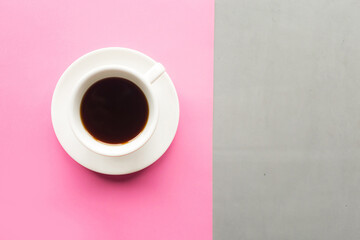 Coffee cup on gray and pink pastel background. Top view. Minimal concept