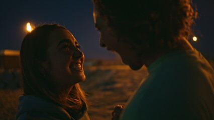 Guy touching girl nose on romantic date night close up.Man kissing girlfriend