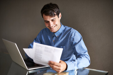Business, documents and happy man with laptop in office for accounting, planning or budget review. Financial, savings and male accountant with paper, invoice or startup growth, profit or sales report