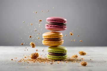 Poster Bright advertising photo, banner. A tower of pink, green and yellow macarons on a plain gray background. Sweet dessert. © TulenMalen