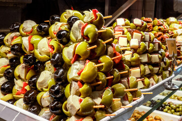 Tapas and pinchos at a food market in Spain. Traditional Spanish gastronomy. Finger food, travelling in Europe - 752173475