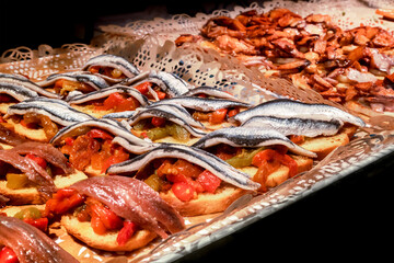 Tapas and pinchos at a food market in Spain. Traditional Spanish gastronomy. Finger food, travelling in Europe - 752173642