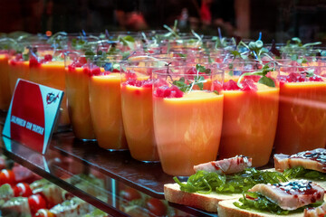 Gazpacho, traditional Spanish cold soup, served as a drink at a food market in Spain, with tapas - 752173827