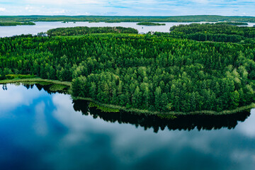 Aerial view of blue lakes and green woods  sunny summer day in Finland from above
