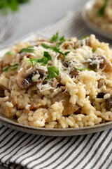 Homemade One-Pot Bacon And Mushroom Risotto on a Plate, low angle view. Close-up.