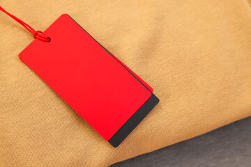 Garment with red tag, top view. Space for text