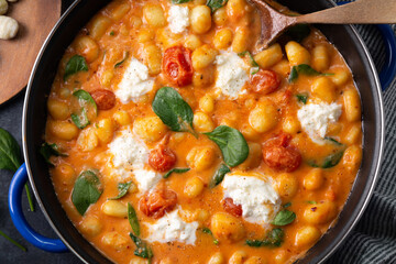 Gnocchi in creamy tomato sauce with baby spinach and melted mozzarella