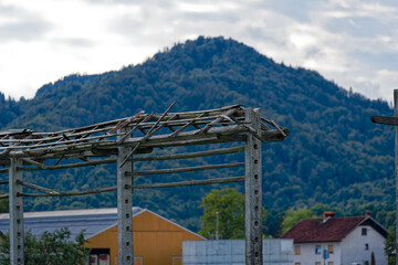 Fototapeta premium Scenic view of hay rack at farmland at village of Zabnica on a blue cloudy summer evening. Photo taken August 10th, 2023, Zabnica, Kranj, Slovenia.