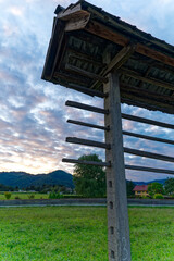 Idyllic close-up view of hayrack at farmland at village of Zabnica on a blue cloudy summer evening. Photo taken August 10th, 2023, Zabnica, Kranj, Slovenia.