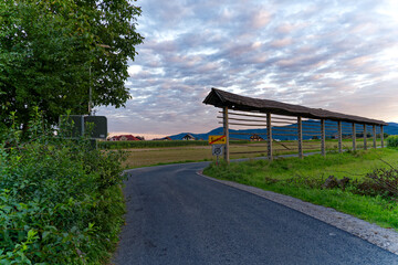 Idyllic view of hayrack at farmland at village of Zabnica on a blue cloudy summer evening. Photo taken August 10th, 2023, Zabnica, Kranj, Slovenia.