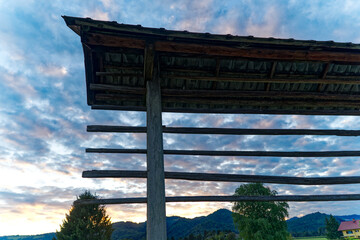 Idyllic close-up view of hayrack at farmland at village of Zabnica on a blue cloudy summer evening....