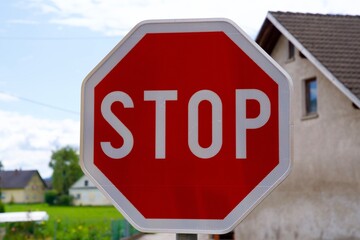 Close up of red and white octagon traffic sign at Slovenian Village of Zabnica on a sunny summer day. Photo taken August 10th, 2023, Zabnica, Kranj, Slovenia.