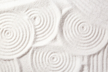 Zen rock garden. Circle patterns on white sand, top view