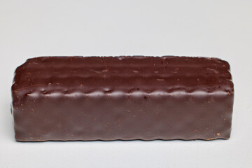 A wafer covered in chocolate on a white background