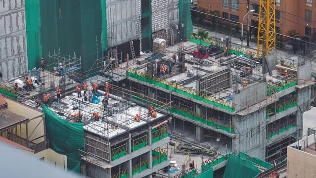 hyperlapse of cranes and workers working on construction site. Advanced construction, architecture or development technology of industrial country concept.