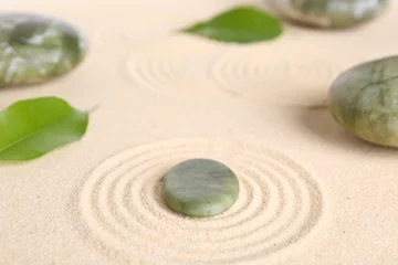 Rolgordijnen Zen garden stones and leaves on beige sand with pattern © New Africa