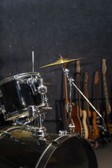 Part of a drum kit with cymbals in a music studio, on stage. Background for photos with live music, rock. Vertical photo