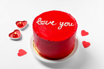 Bento cake with text Love You, candles and paper hearts on white table. St. Valentine's day surprise