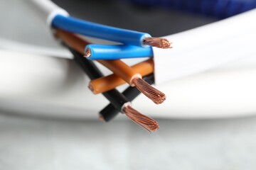 Colorful electrical wires on blurred background, closeup