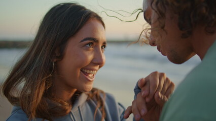 Closeup man kissing woman hands evening coast. Young pair dating at sunset ocean