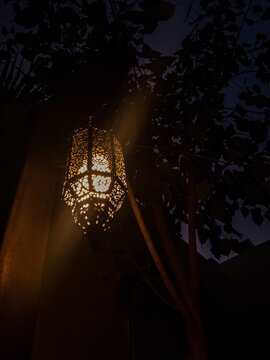 A lit Ramadan lantern in the dark