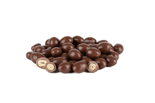 A pile of dark chocolate covered peanuts on a white background.