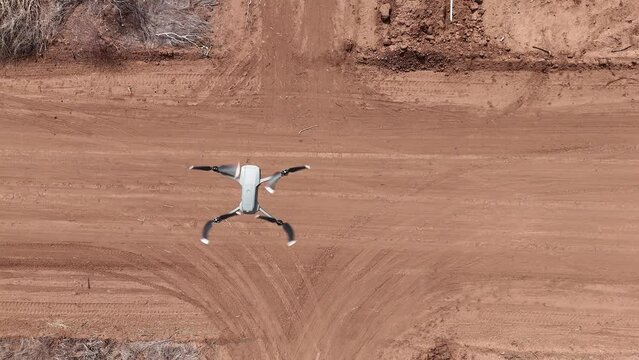 Drone Zenithal View Of A Flying Drone With Rural Dirt Road In The Background